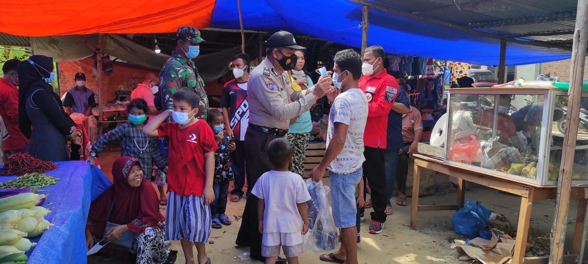 Lakukan Patroli, Polsek Langgam Sekaligus Bagikan Masker Gratis Kepada Warga